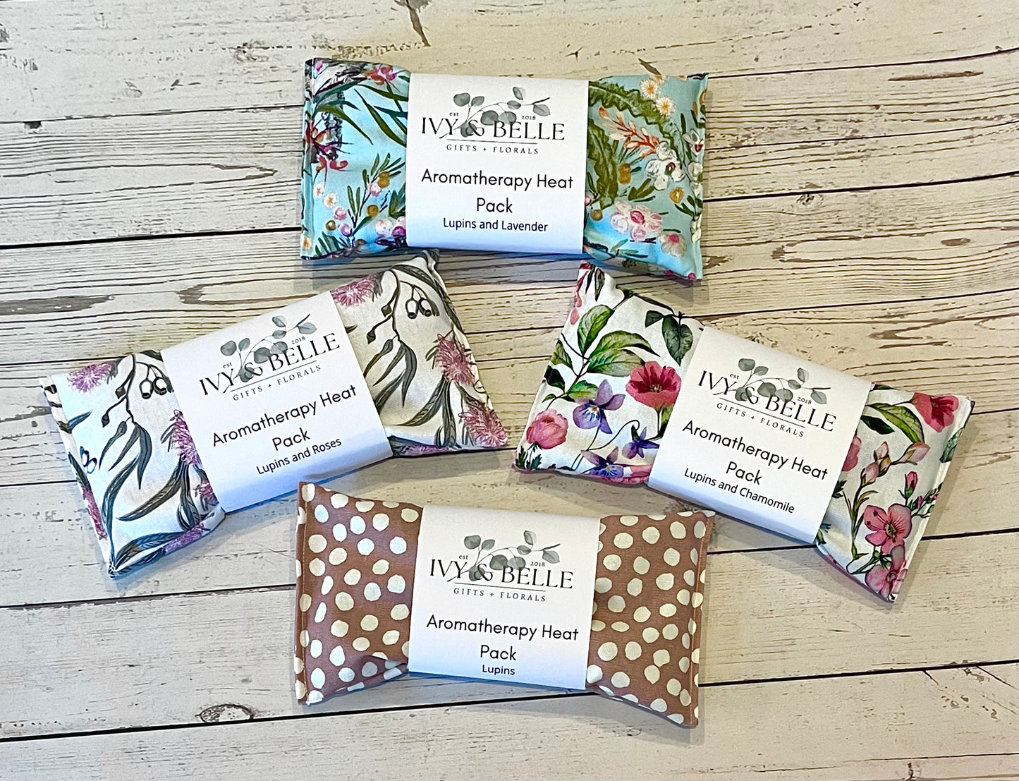 Four differently patterned aromatherapy heat packs containing lupins.